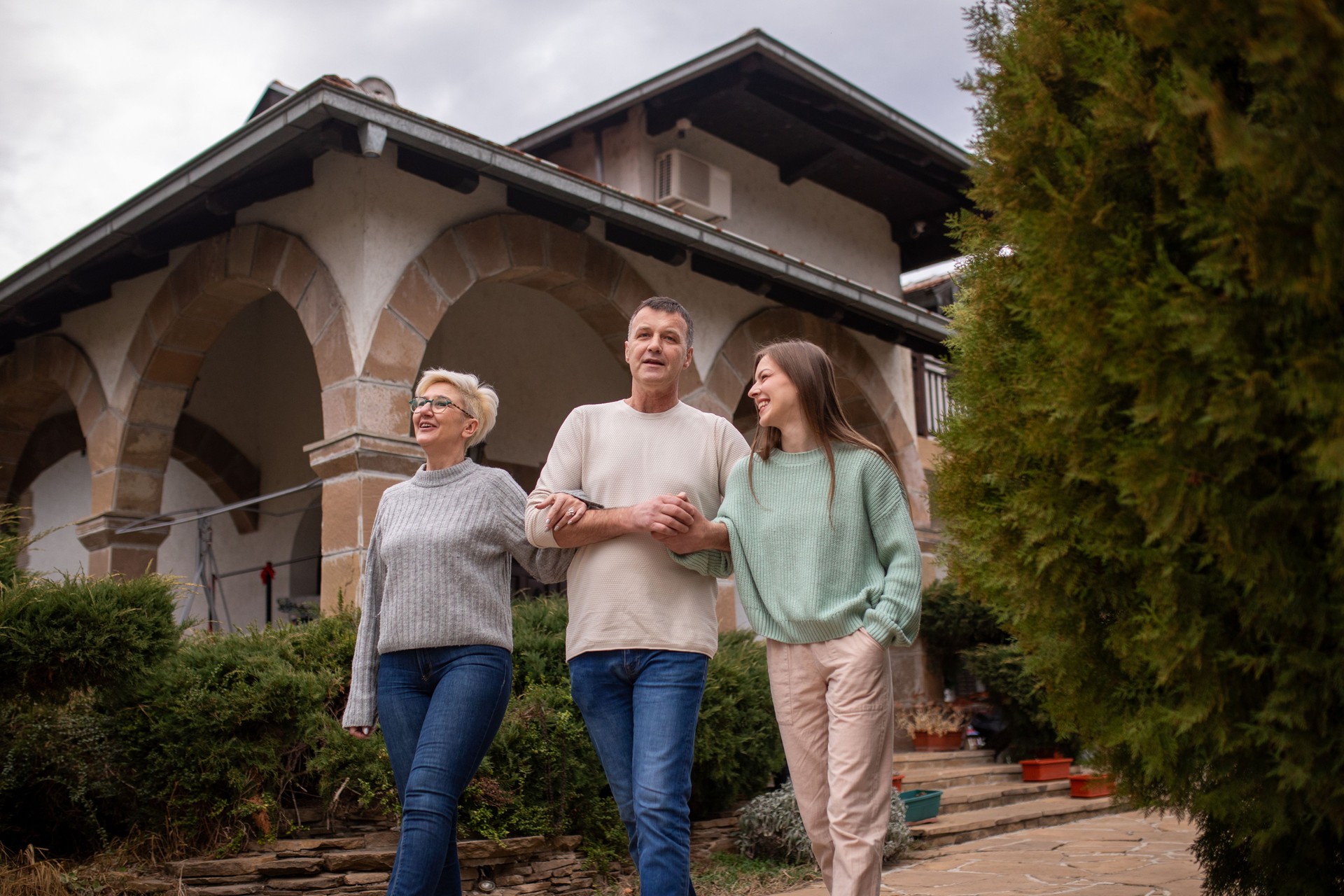 A family admiring their home outdoors