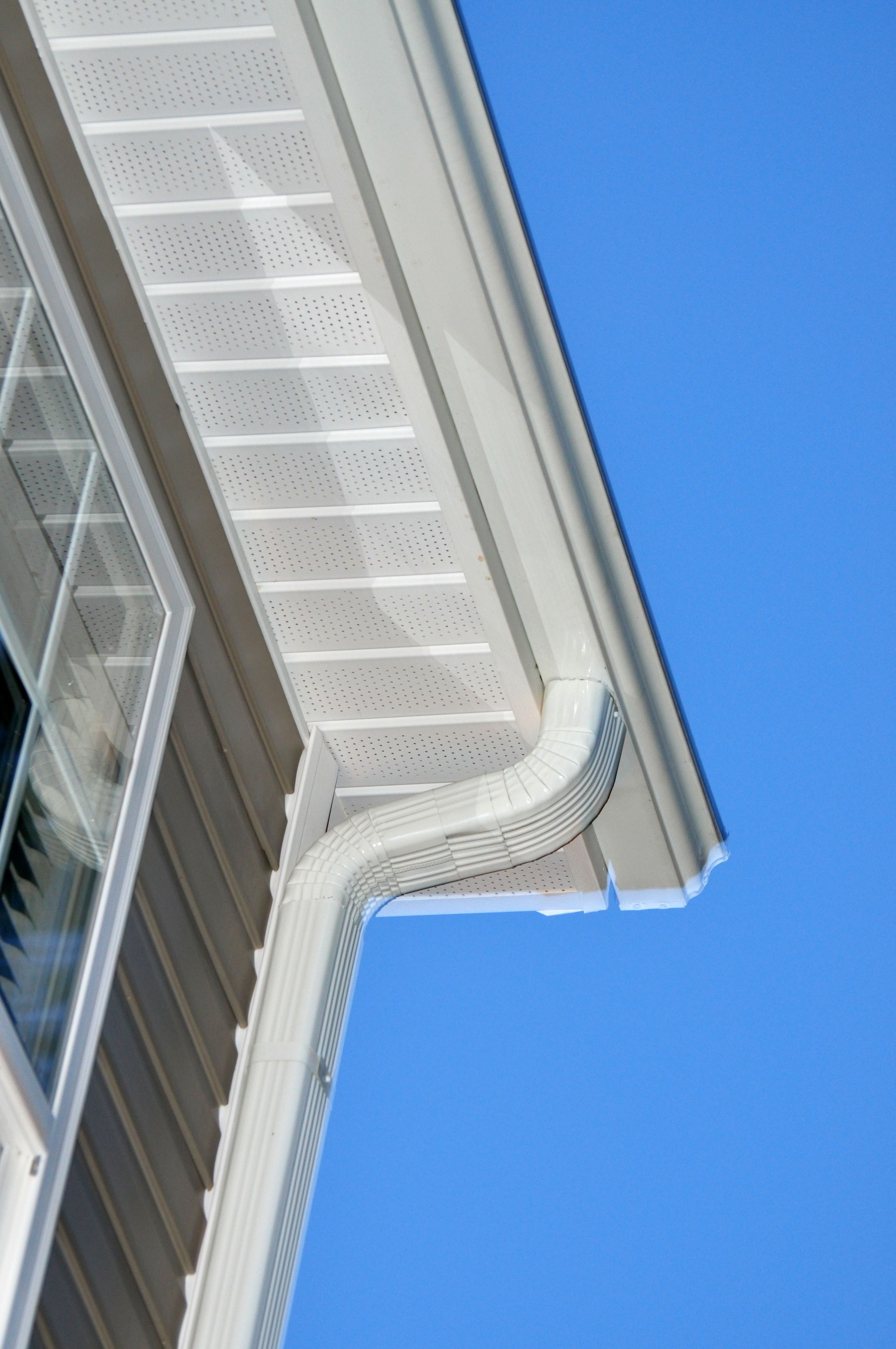 Looking up at a modern gutter pipe