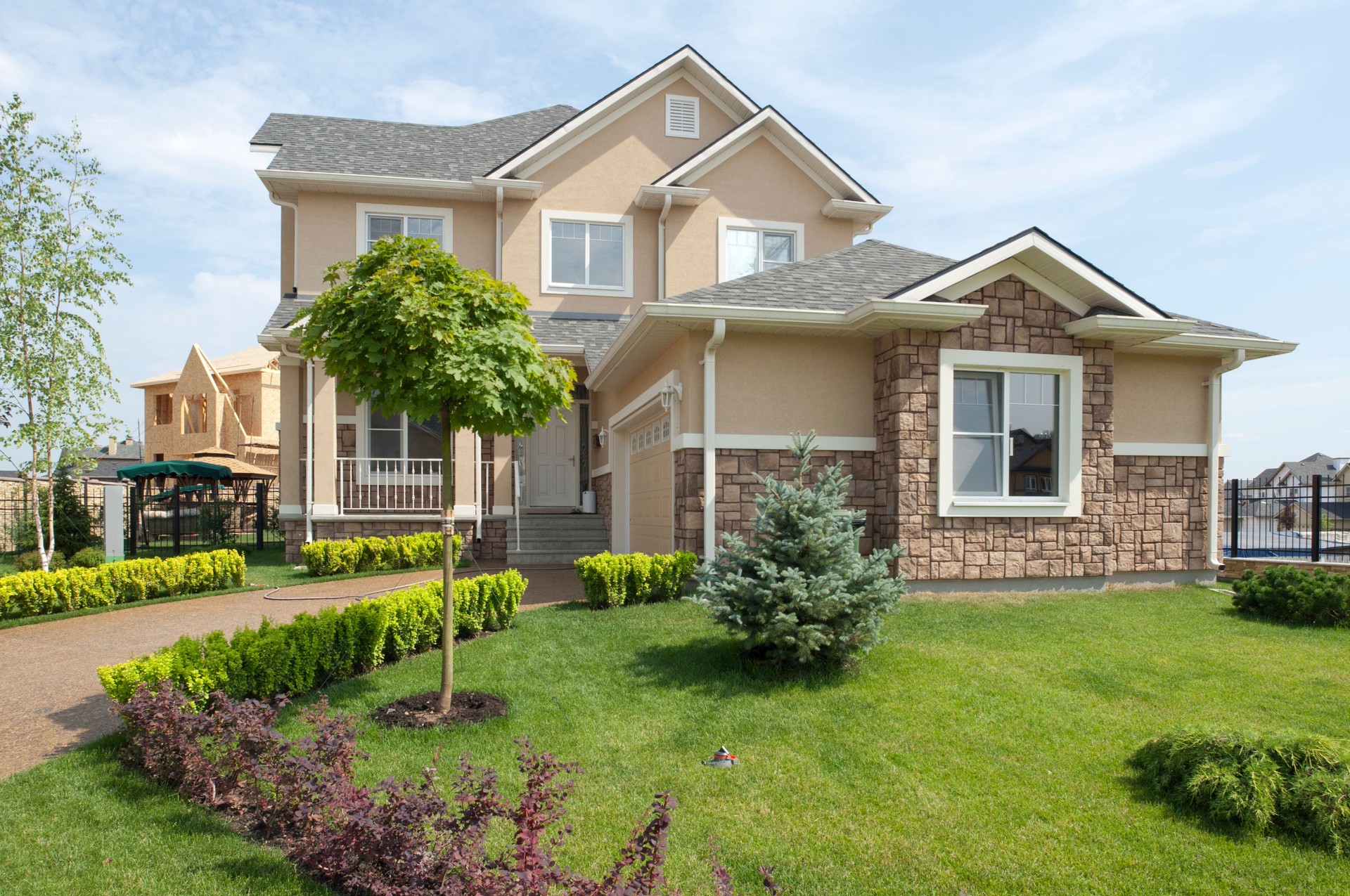 Brand new suburban house in sunny summer afternoon