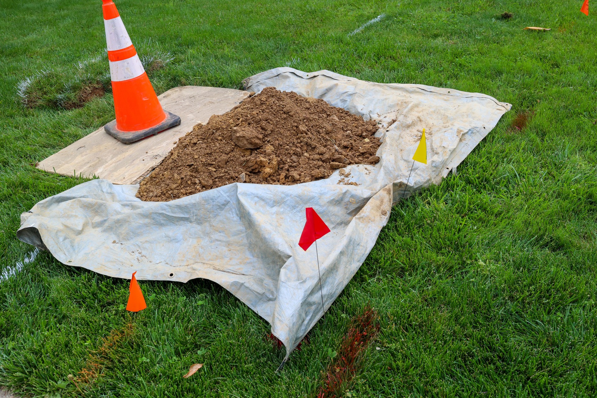 A Pile Of Dirt From Underground Repair Work On A Lawn